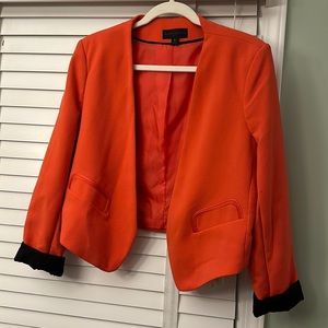 Worthington bright orange cropped blazer with black sleeve detail. Size large.
